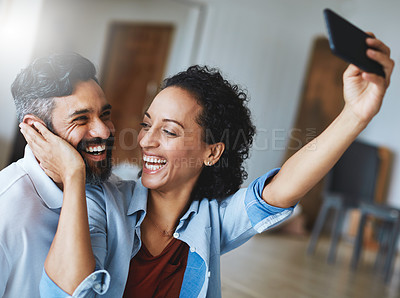 Buy stock photo Happy couple, smile and love for selfie, profile picture or social media vlog together relaxing at home. Man and woman in relationship smiling for photo, online post or bonding memory in living room