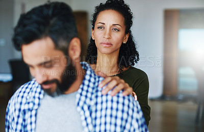 Buy stock photo Shot of a woman comforting her distraught husband at home