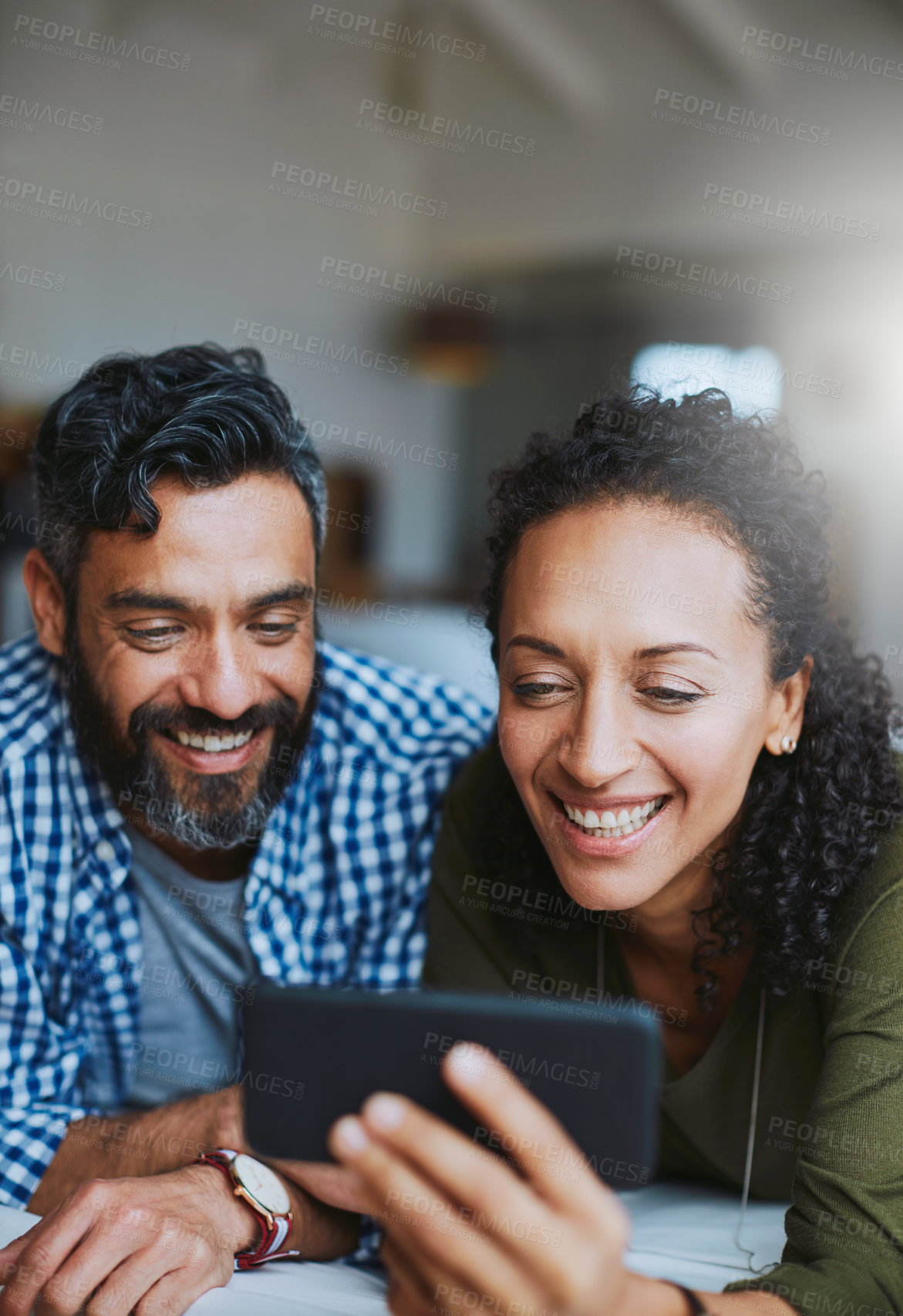 Buy stock photo Shot of a laid-back couple relaxing with wireless technology at home