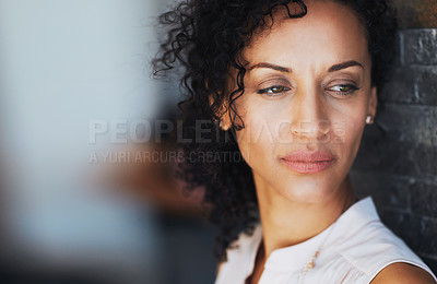 Buy stock photo Shot of an introspective woman leaning against a brick wall at home