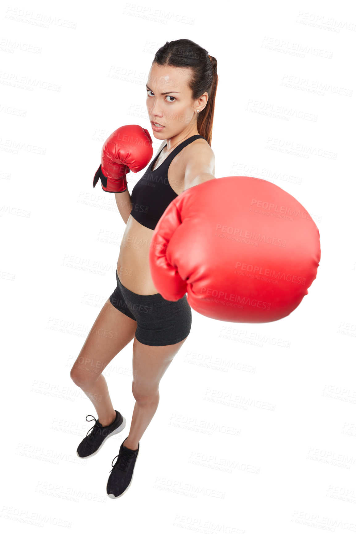 Buy stock photo High angle portrait of a young female athlete boxing against a white background