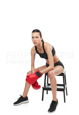 Buy stock photo Full length portrait of a young female boxer sitting on a stool during a match