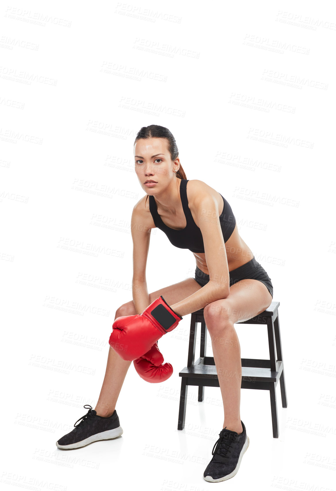 Buy stock photo Full length portrait of a young female boxer sitting on a stool during a match