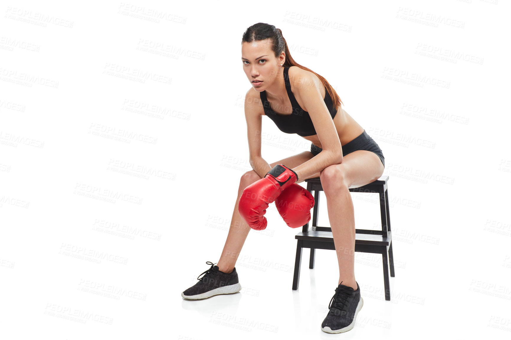 Buy stock photo Full length portrait of a young female boxer sitting on a stool during a match