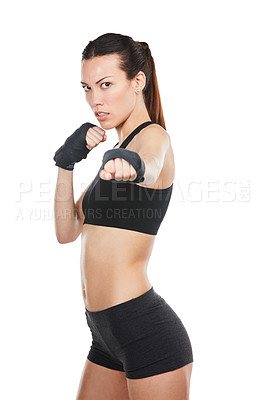 Buy stock photo Cropped portrait of a young female athlete kick-boxing against a white background