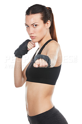 Buy stock photo Cropped portrait of a young female athlete kick-boxing against a white background