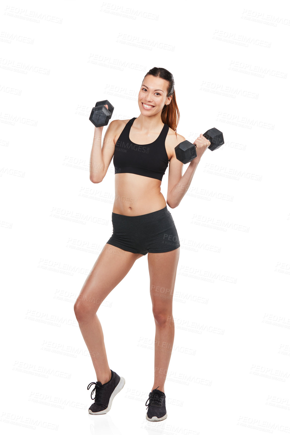 Buy stock photo Studio shot of a young woman working out with dumbbells against a white background