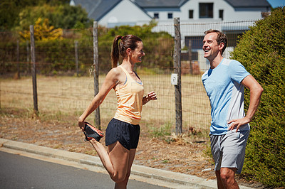 Buy stock photo Shot of a happy couple jogging together in their neighborhood