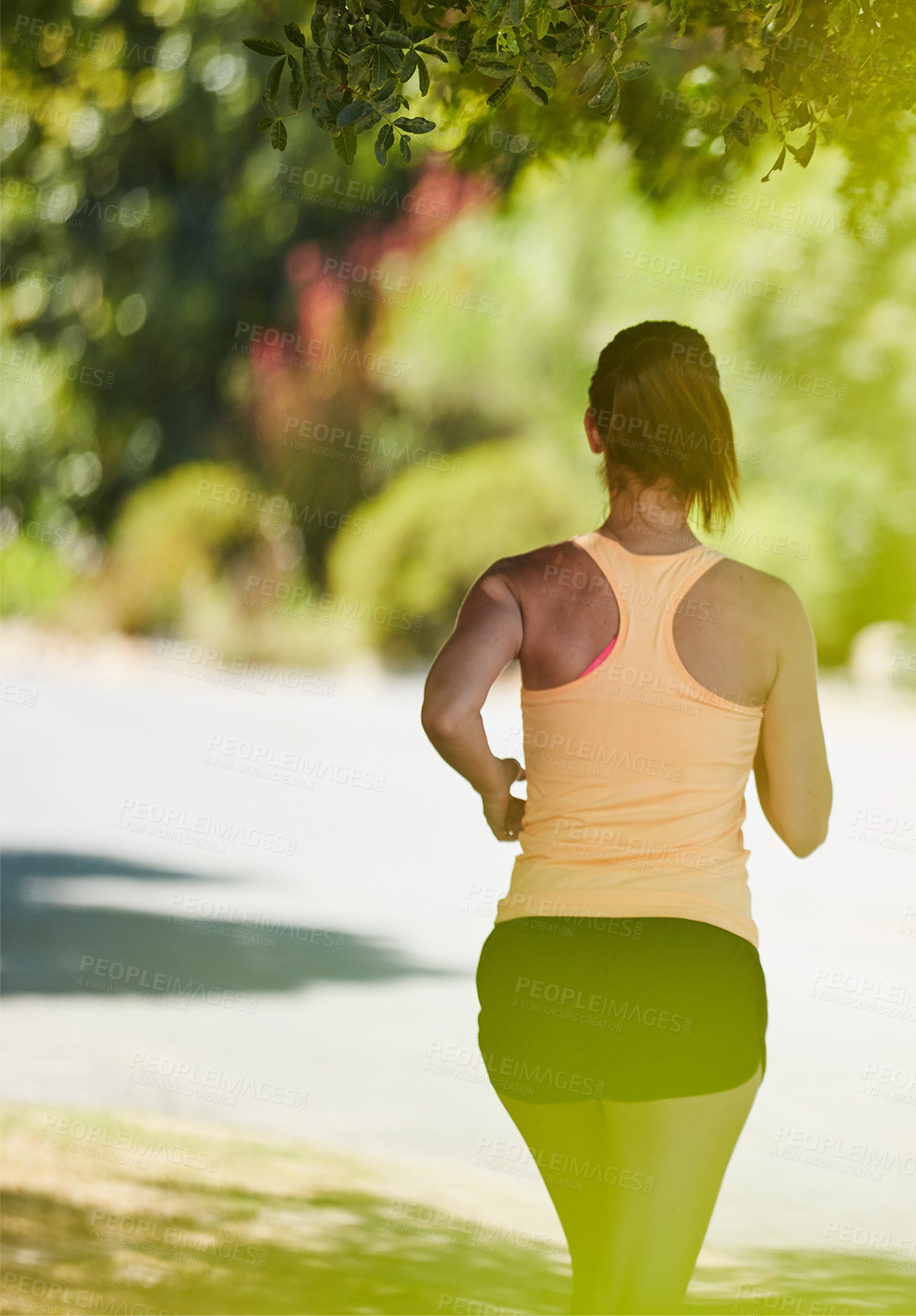 Buy stock photo Rearview shot of an unidentifiable woman jogging in her neighborhood