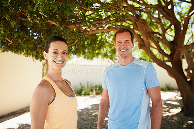 Buy stock photo Portrait of a happy couple jogging together in their neighborhood