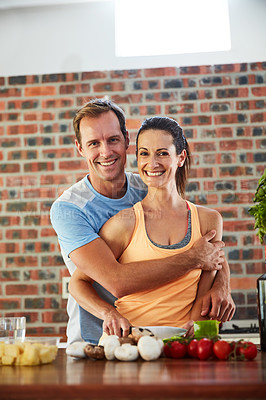 Buy stock photo Portrait of a relaxed couple cooking together in their kitchen at home