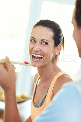 Buy stock photo Shot of a relaxed couple cooking together in their kitchen at home