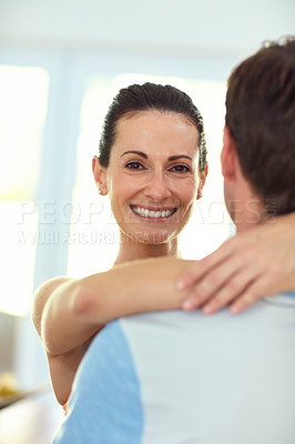 Buy stock photo Portrait of a happy woman embracing her husband at home