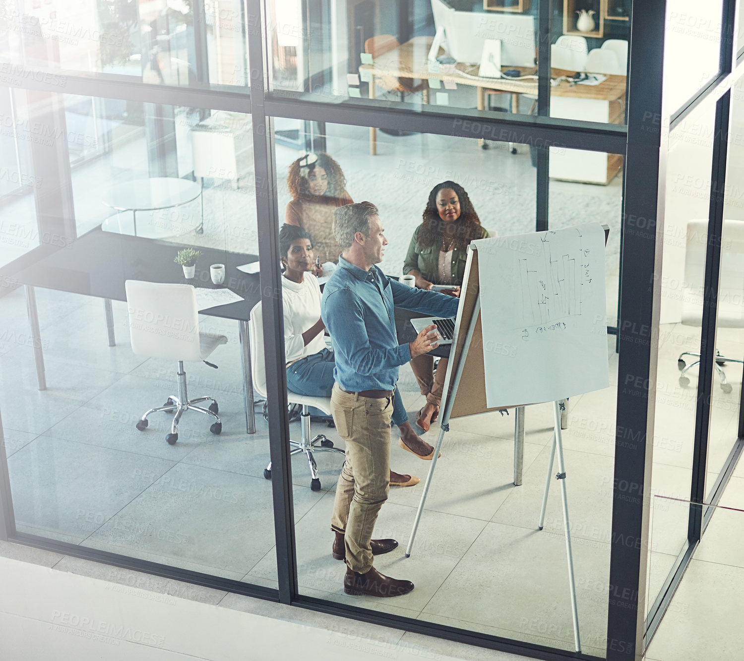 Buy stock photo High angle shot of a group of businesspeople having a meeting in a boardroom