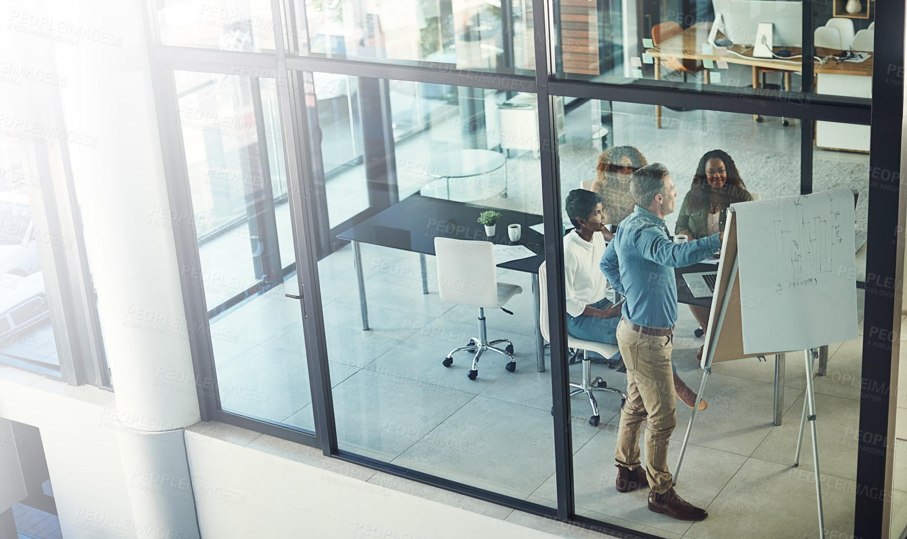 Buy stock photo High angle shot of a group of businesspeople having a meeting in a boardroom