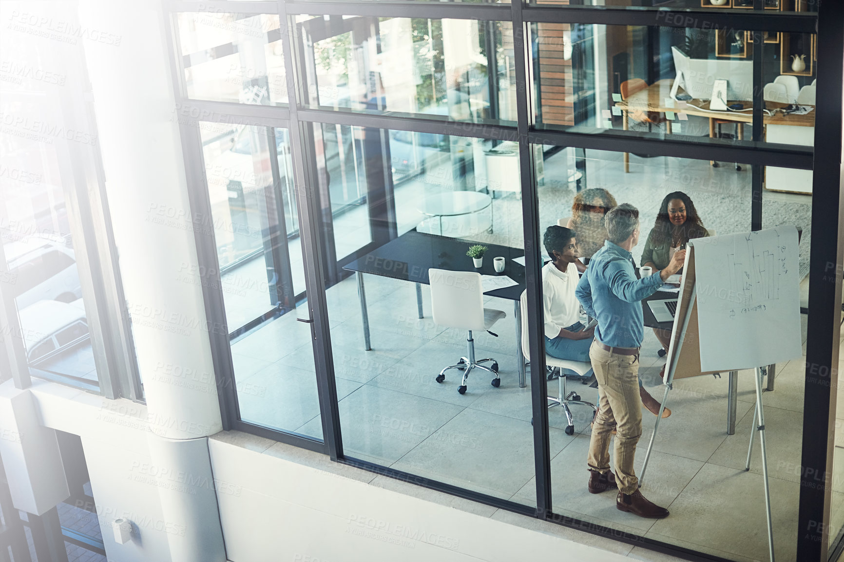 Buy stock photo High angle shot of a group of businesspeople having a meeting in a boardroom