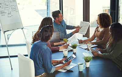 Buy stock photo Cropped shot of a group of businesspeople having a meeting in an office