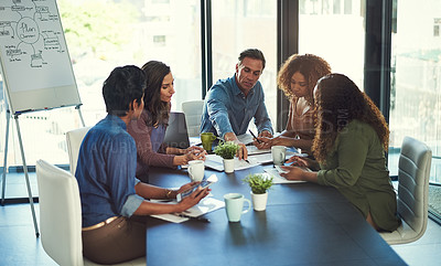 Buy stock photo Cropped shot of a group of businesspeople having a meeting in an office