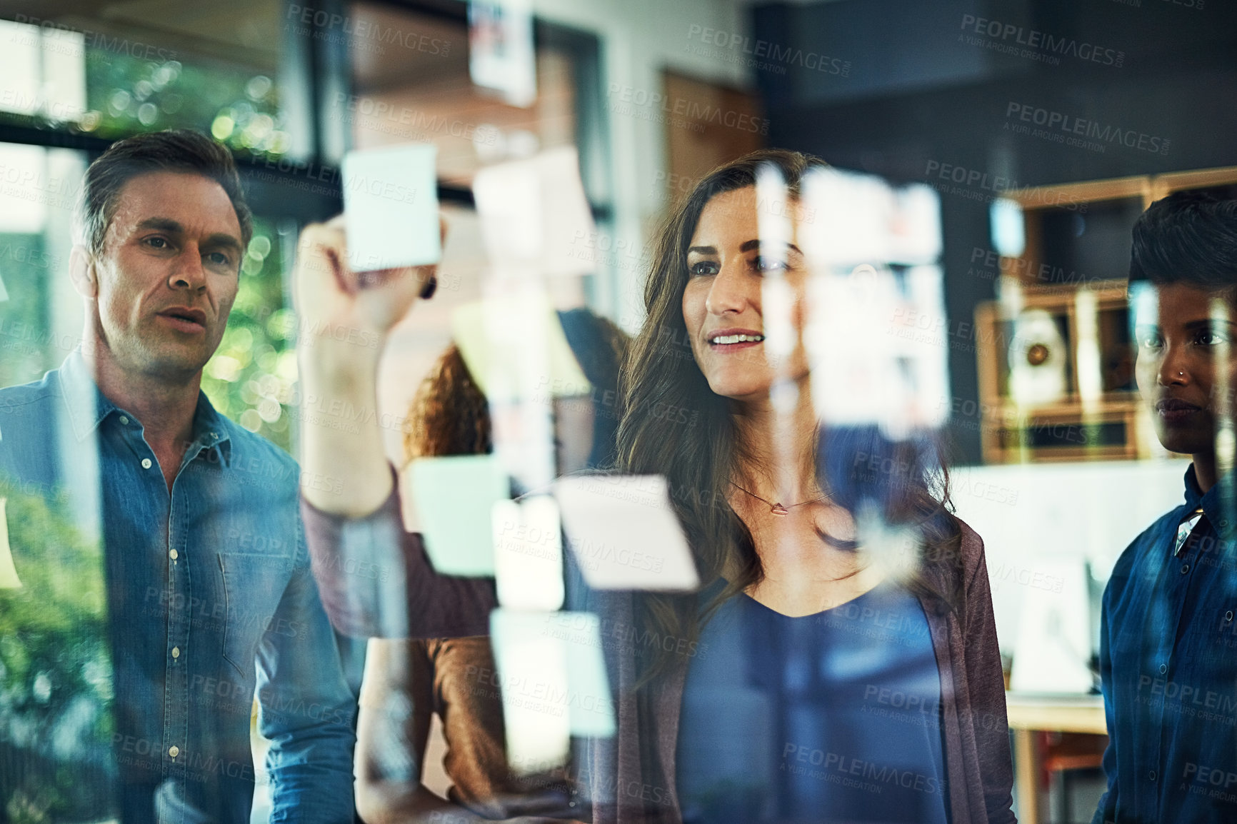 Buy stock photo Moodboard, sticky notes and writing with business people in office together for brainstorming. Glass wall, meeting and training with professional colleague group in workplace for strategy discussion