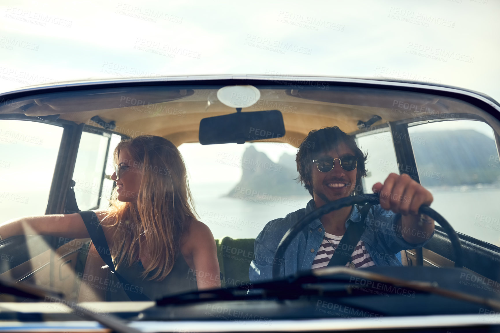 Buy stock photo Cropped shot of an affectionate young couple taking a roadtrip together