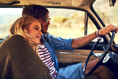 Buy stock photo Cropped shot of an affectionate young couple taking a roadtrip together
