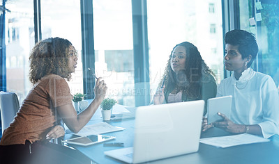 Buy stock photo Cropped shot of a group of businesswomen having a discussion in the boardroom