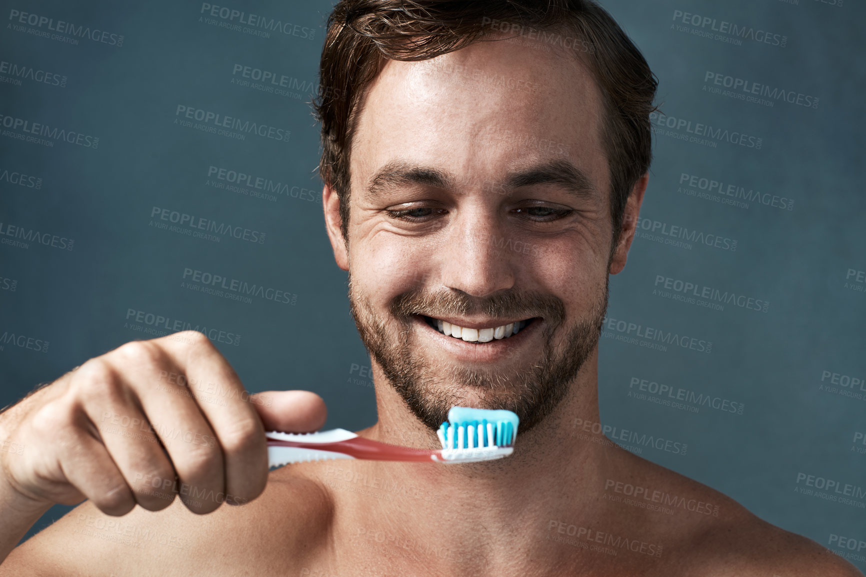 Buy stock photo Hygiene, man and toothbrush topless in studio background with smile for dental health, wellness or mouth care. Male person, happy and oral product isolated backdrop for clean teeth and fresh breath