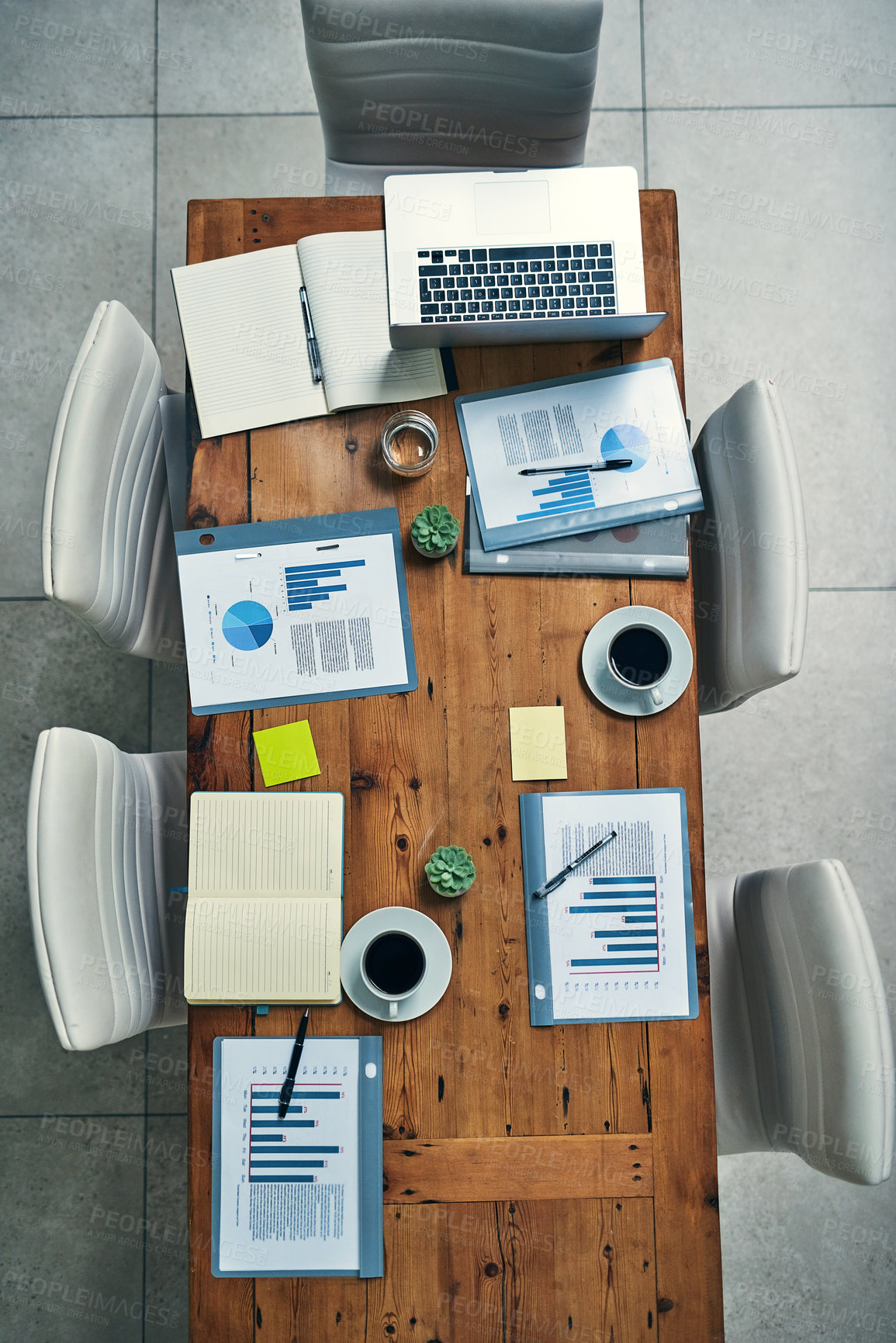 Buy stock photo Above, documents and graphs on table for finance meeting, annual report and financial review in office. Boardroom, desk and laptop in workplace with paperwork, charts and information in workspace