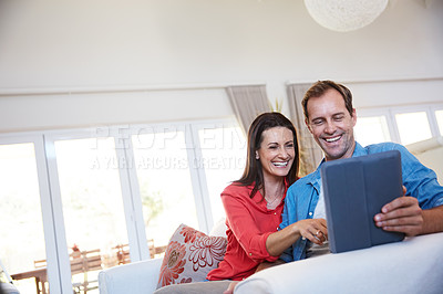 Buy stock photo Shot of a mature couple using a digital tablet together at home
