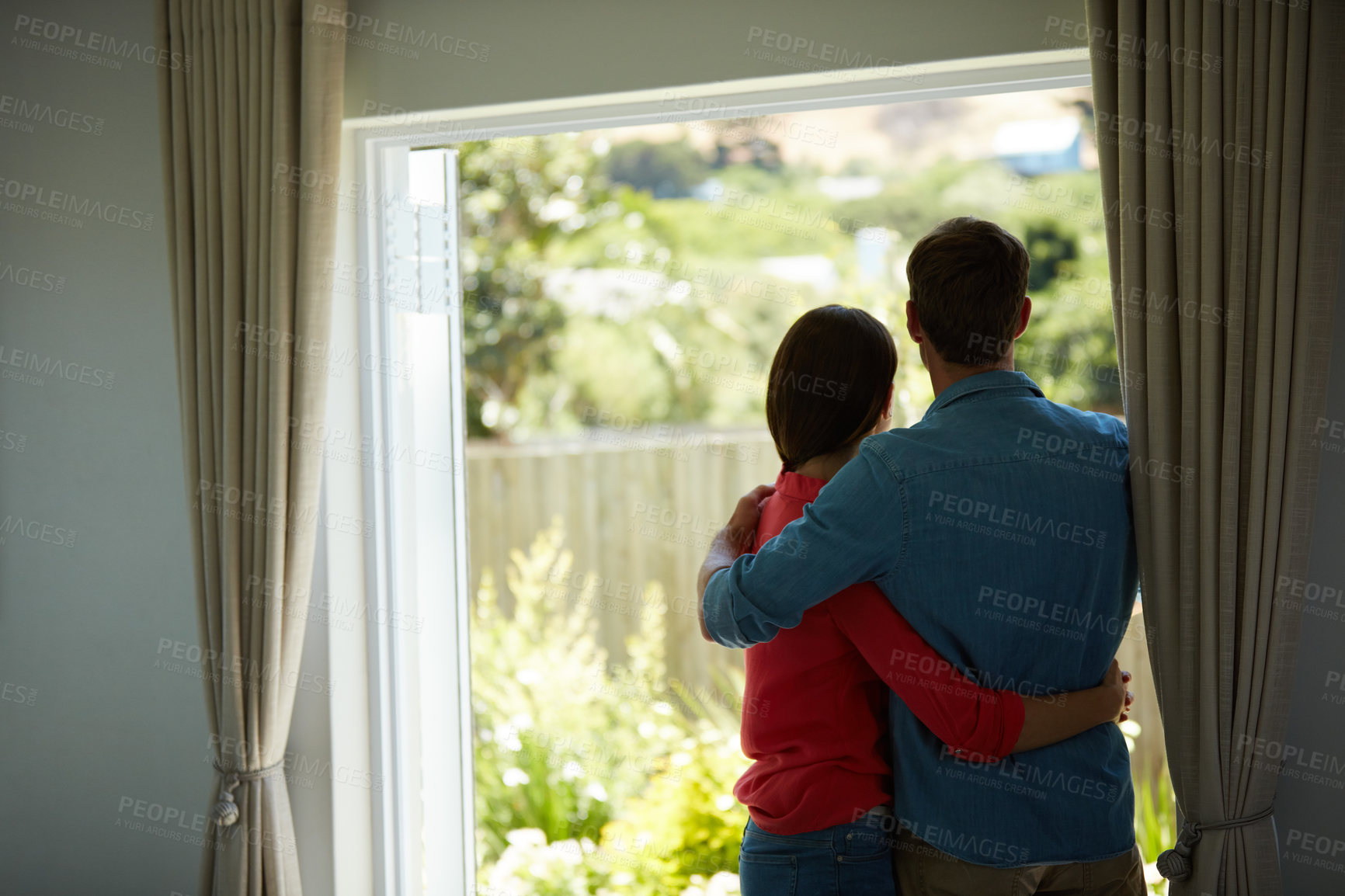 Buy stock photo Rear view shot of a mature couple looking out the window at home together