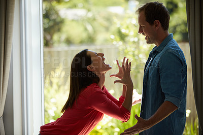 Buy stock photo Shot of a mature couple having relationship problems at home