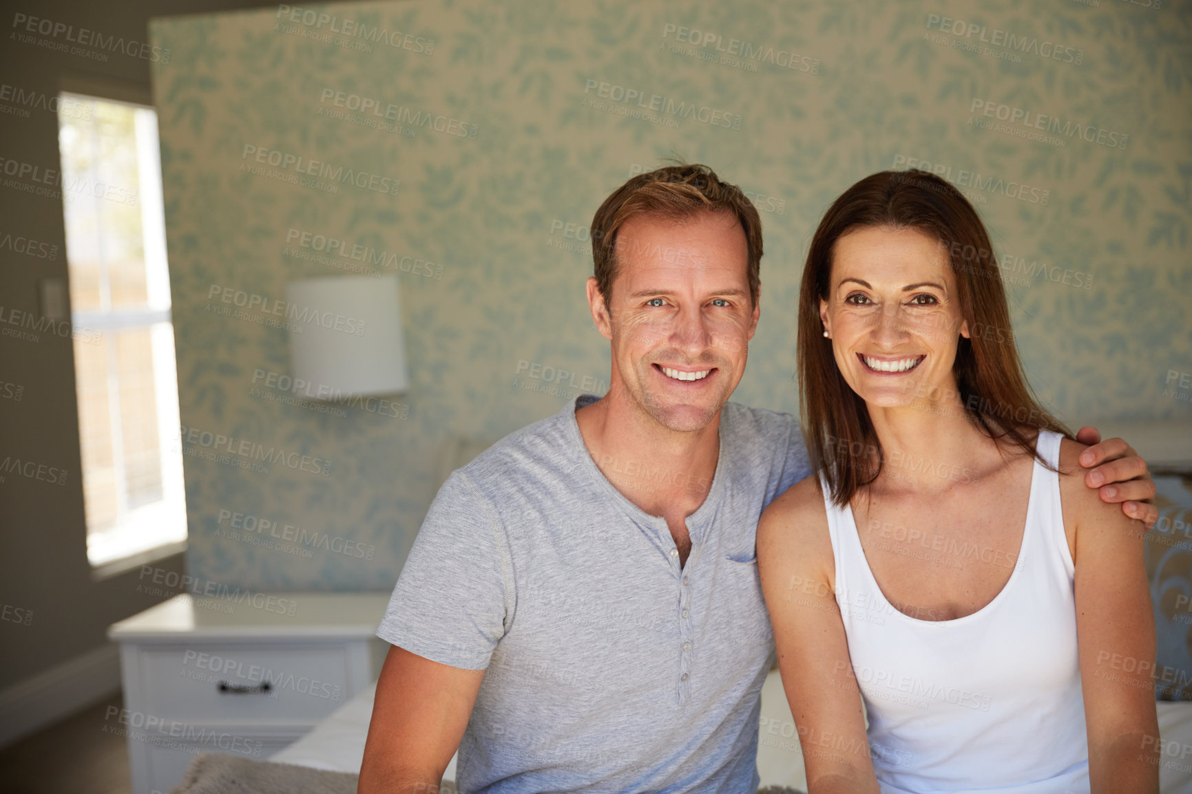 Buy stock photo Portrait of a mature couple relaxing together in their bedroom