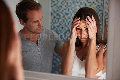 Buy stock photo Shot of a man comforting his distraught wife at home