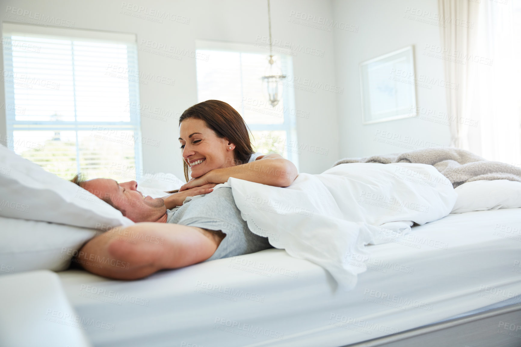 Buy stock photo Shot of a mature couple relaxing together in bed