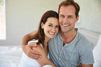 Buy stock photo Portrait of a mature couple relaxing together in their bedroom