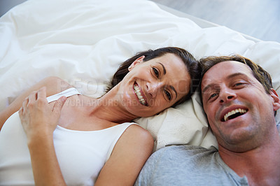 Buy stock photo Portrait of a mature couple relaxing in bed together