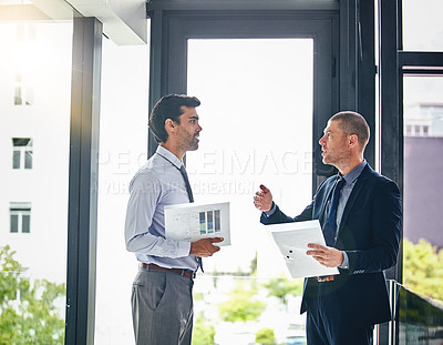 Buy stock photo Cropped shot of two businessmen having a discussion in an office