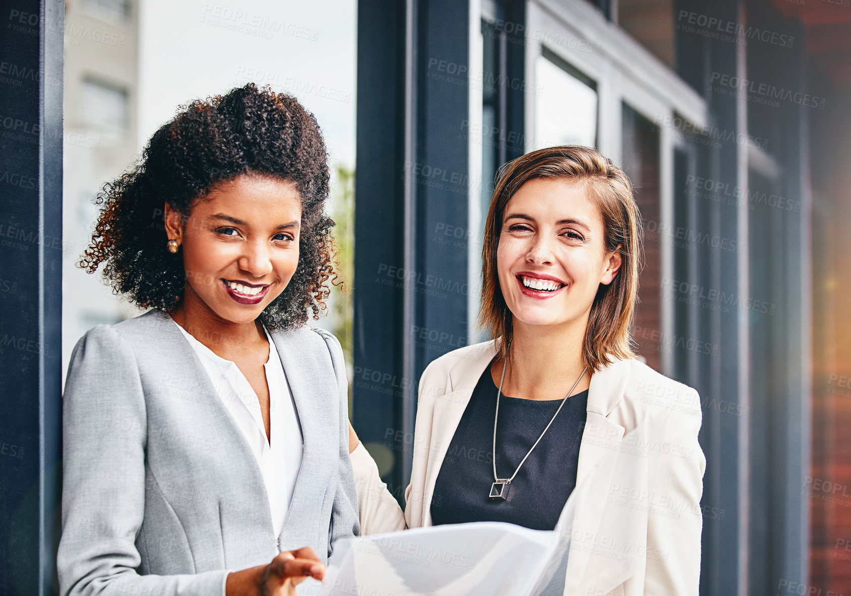 Buy stock photo Portrait of two businesswomen having a discussion outside an office