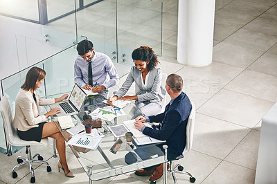 Buy stock photo Shot of a group of businesspeople having a meeting
