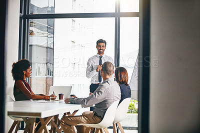 Buy stock photo Shot of a businessman giving a presentation to coworkers in a boardroom meeting