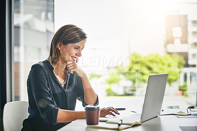 Buy stock photo Cropped shot of a young businesswoman working on a laptop in an office