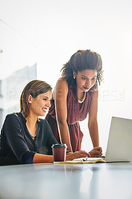 Buy stock photo Cropped shot of two businesswomen working together on a laptop in an office