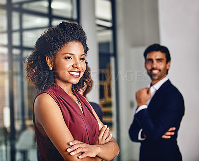 Buy stock photo Cropped shot of a young businesswoman looking thoughtful with her colleague in the background