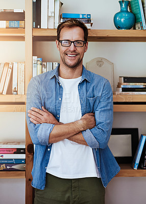 Buy stock photo Cropped portrait of a handsome man standing with his arms crossed at home