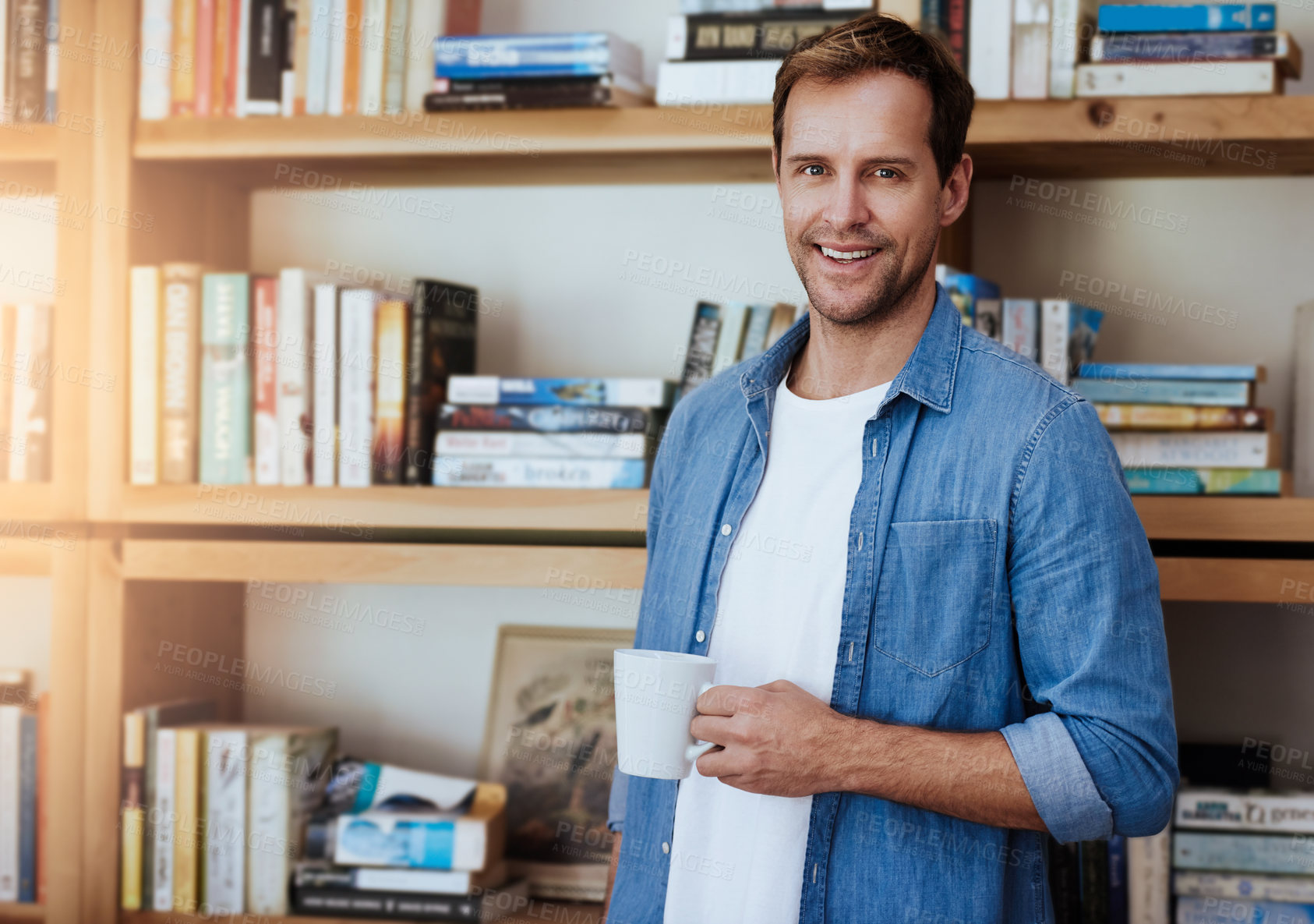 Buy stock photo Cropped portrait of a handsome man drinking a coffee at home
