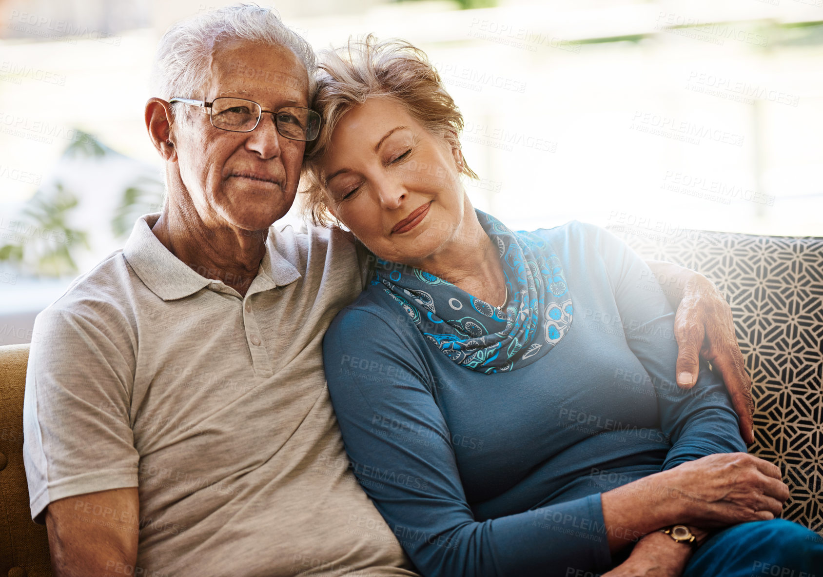 Buy stock photo Portrait of a senior couple relaxing together on the sofa at home