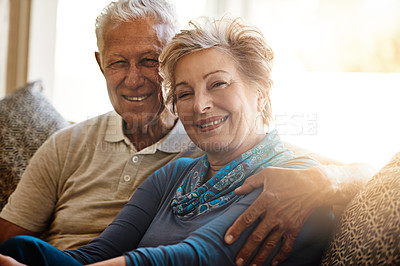 Buy stock photo Portrait of a senior couple relaxing together on the sofa at home