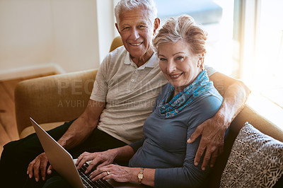 Buy stock photo Portrait of a happy senior couple using a laptop together on the sofa at home