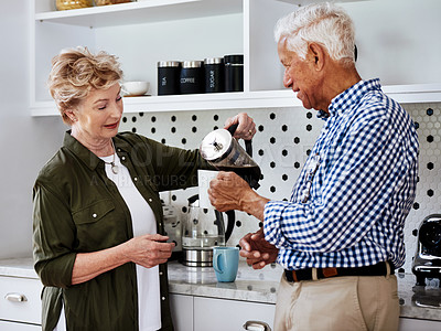 Buy stock photo Cropped shot of a senior couple drinking coffee together at home