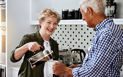 Buy stock photo Cropped shot of a senior couple drinking coffee together at home